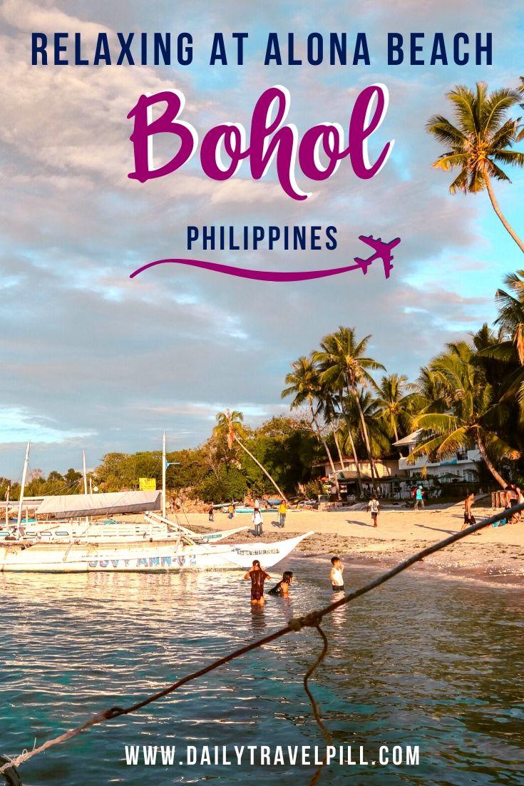 Alona Beach Bohol at sunset - palm trees and boats