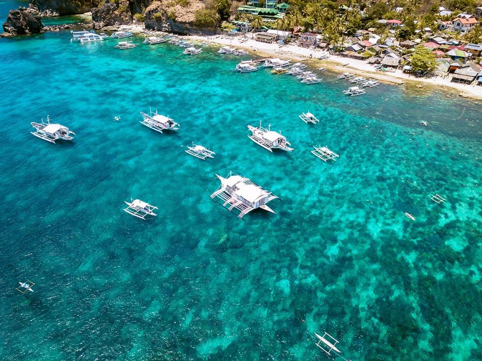 Drone view of boats at Apo Island, Philippines