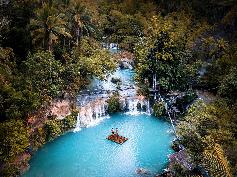couple on a bamboo raft at Cambugahay Falls, Siquijor