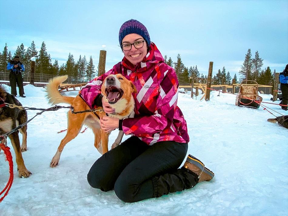 Girl playing with a husky dog in Lapland, Finland