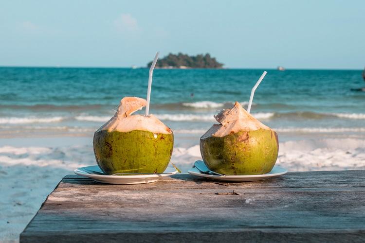 Two coconuts on a table at Long Set Beach Koh Rong