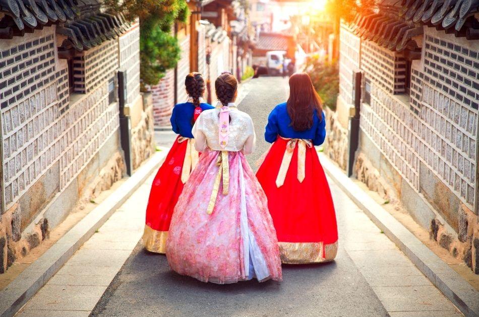 Korean girls in hanbok walking around Bukchon Hanok Village in Seoul