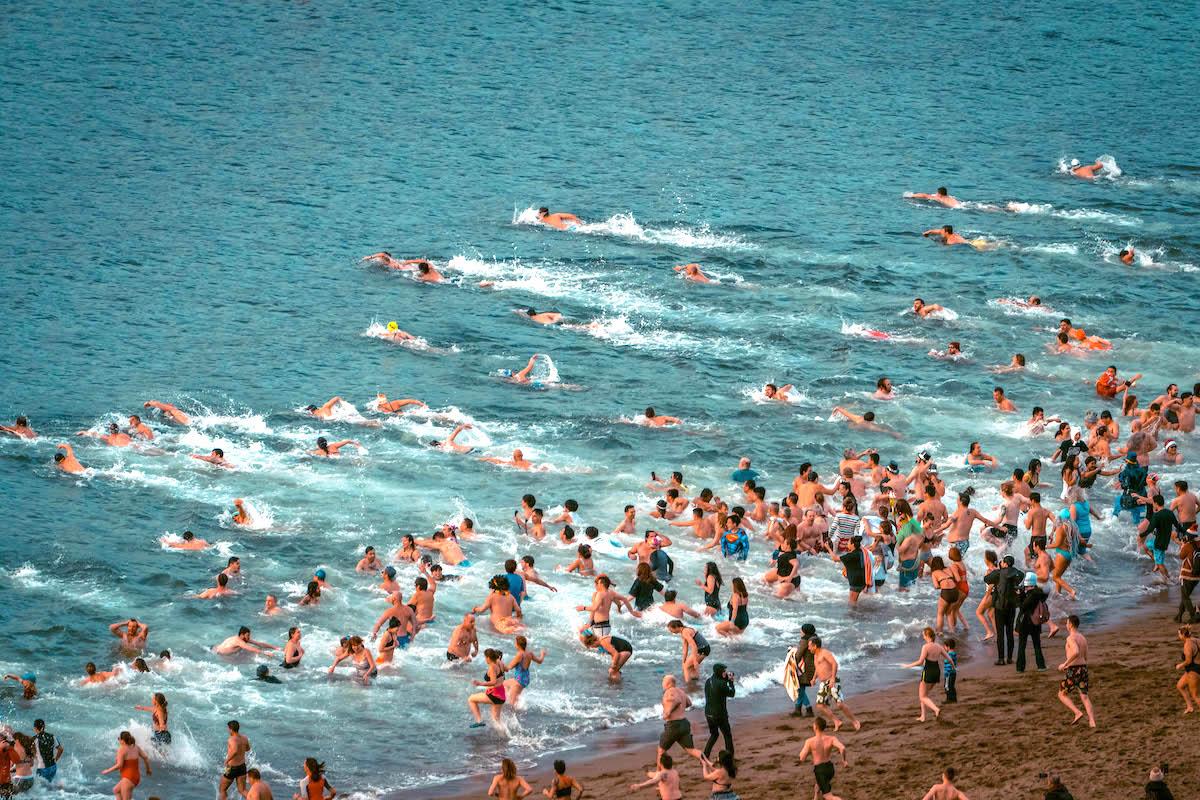 Seogwipo Penguin Festival on Jeju Island. People swimming in icy water in winter - things to do in Korea in Winter, winter destinations in Korea, winter activities in South Korea