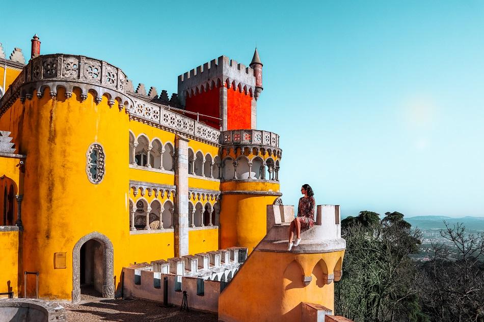 Aurelia Teslaru sitting on a tower at Pena Palace, Sintra