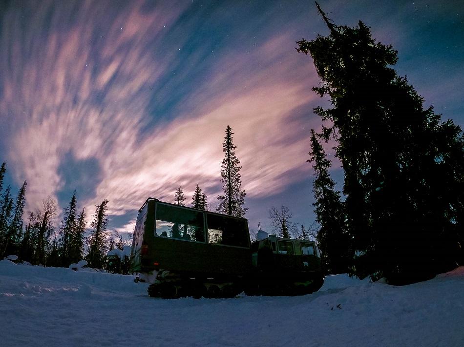 Snow tank inside forest at night in Lapland, Finland