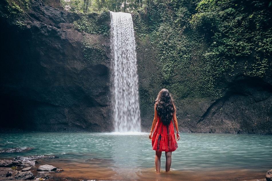 Girl at Tibumana Waterfall Bali, waterfall near Ubud