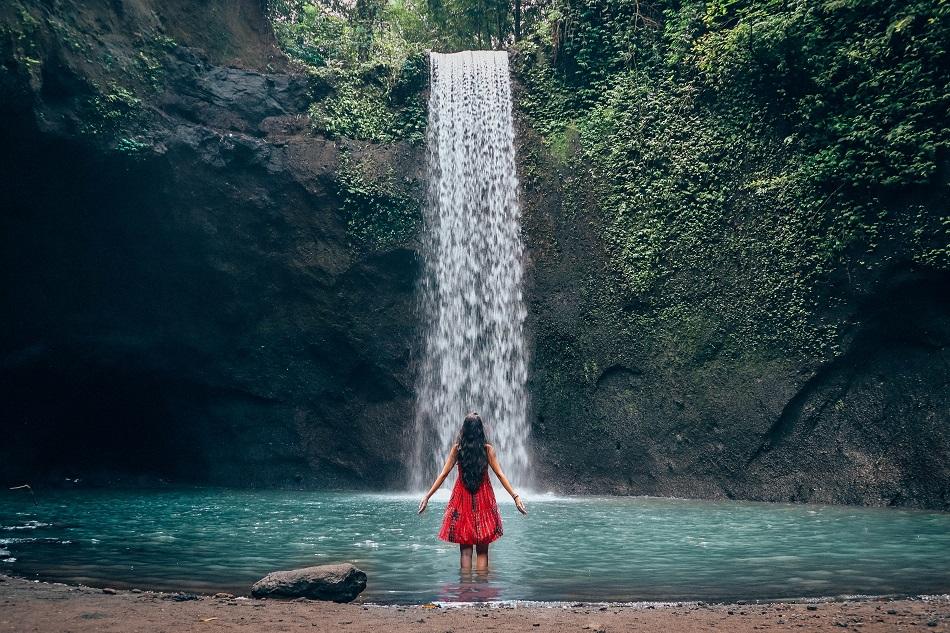 Girl at Tibumana Waterfall Bali, waterfall near Ubud