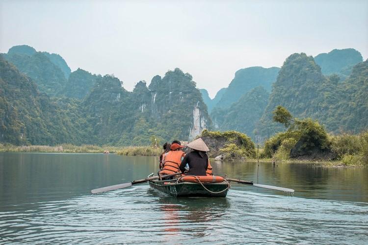 Trang An boat ride. Vietnamese rower in a boat